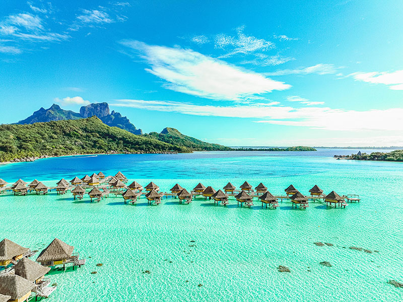 Aerial view of Bora Bora Lagoon with multiple huts overlooking the water